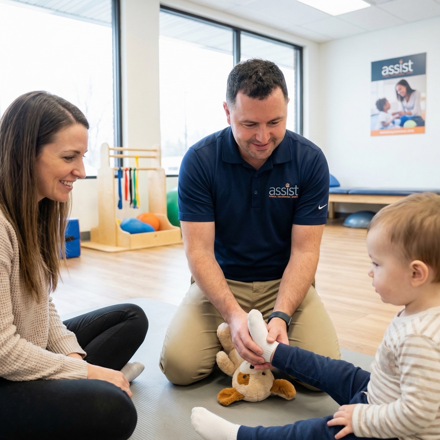 Therapist and parent engaging a young child during a pediatric therapy activity